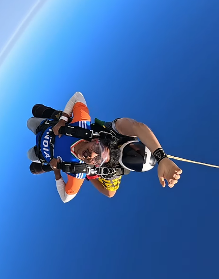 Early freefall — the body horizontal, Dubai somewhere below, the blue of the sky in every direction