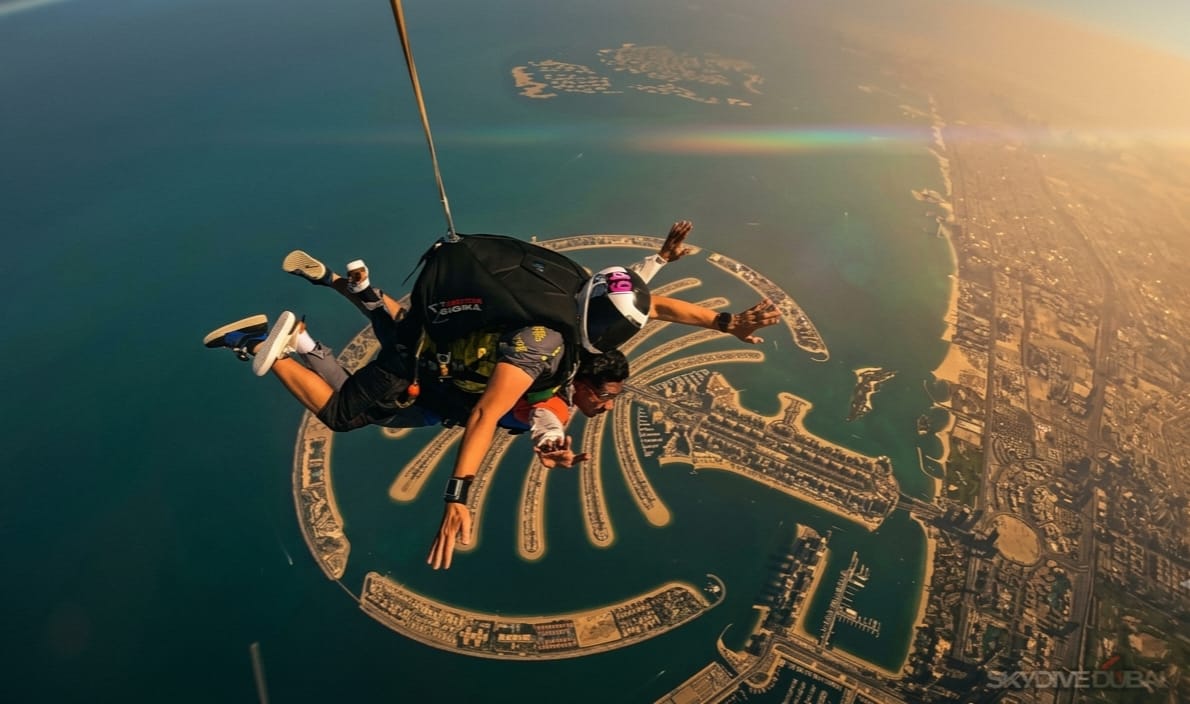 Tandem skydive over Palm Jumeirah, Dubai — the full palm-shaped island visible from freefall