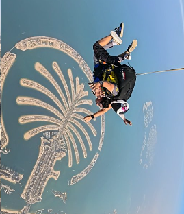 Tandem freefall over Palm Jumeirah — the full shape of the island visible from 13,000 feet